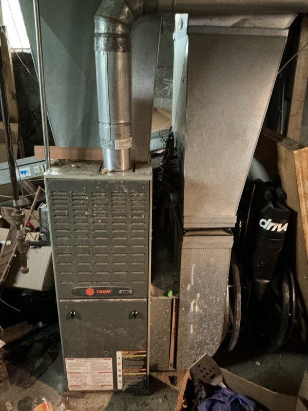 Completed furnace inspection on Trane heating unit located in basement utility area. Assessed overall system condition, ductwork connections, and operational components to provide replacement estimate. Documented existing equipment configuration including air handler, ventilation system, and associated mechanical components for homeowner's consideration of system replacement options.