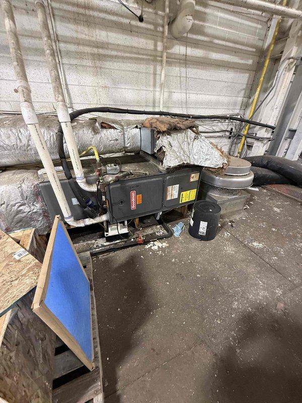 Responded to no cooling complaint for commercial air conditioning system located on second floor. Upon arrival, inspected outdoor condenser unit mounted on wooden platform against exterior wall and indoor air handler in mechanical room with associated ductwork. Evaluated refrigerant lines, electrical connections, and overall system operation. Performed diagnostic testing to identify cause of cooling failure. Checked airflow through deteriorated ductwork insulation and verified proper drainage through PVC condensate lines. Assessed condenser coil condition and compressor operation. Restored cooling functionality to single AC unit and confirmed system operating within normal parameters before departure.