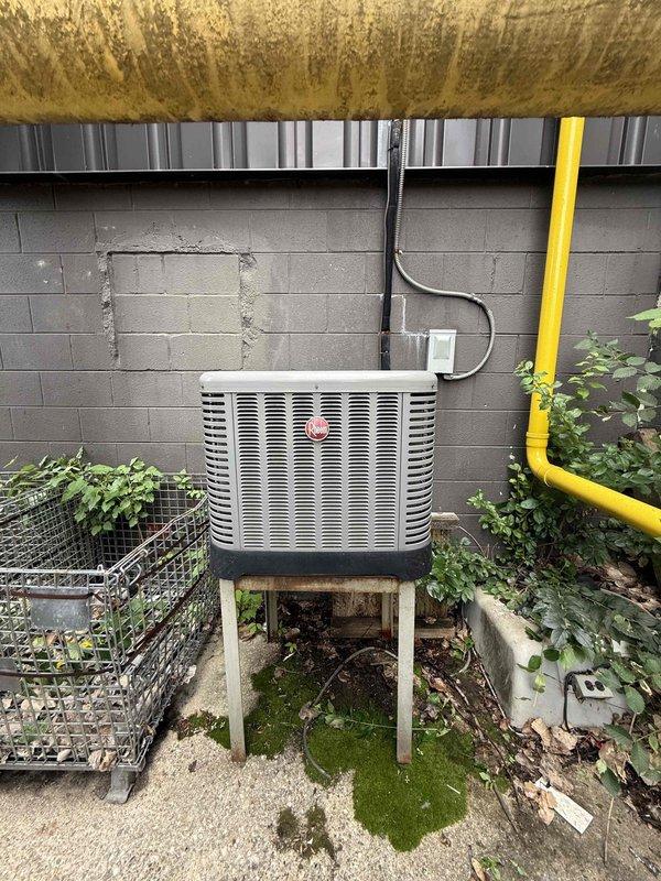 Responded to no cooling complaint for commercial air conditioning system located on second floor. Upon arrival, inspected outdoor condenser unit mounted on wooden platform against exterior wall and indoor air handler in mechanical room with associated ductwork. Evaluated refrigerant lines, electrical connections, and overall system operation. Performed diagnostic testing to identify cause of cooling failure. Checked airflow through deteriorated ductwork insulation and verified proper drainage through PVC condensate lines. Assessed condenser coil condition and compressor operation. Restored cooling functionality to single AC unit and confirmed system operating within normal parameters before departure.