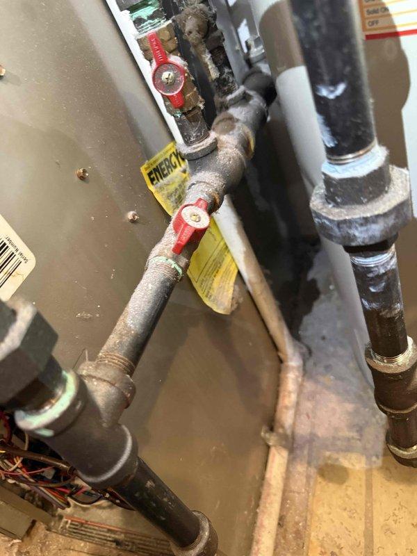 Completed comprehensive Gold AC Inspection on 20-year-old air conditioning system located in basement. Performed electrical diagnostics on outdoor condensing unit using digital multimeter, verifying voltage readings at 238.5V and confirming proper electrical operation. Inspected condenser fan motor, fan guard assembly, and all accessible components of the outdoor unit for operational integrity. Examined indoor plumbing connections, shut-off valves, and associated HVAC infrastructure. Applied energy efficiency identification tag to system piping for future reference. Replaced humidifier pad on furnace as requested during service visit. All systems operating within normal parameters at time of inspection.