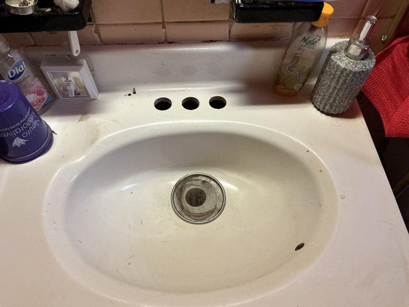 Responded to service call for installation of two bathroom faucets. Successfully removed existing fixtures and installed new chrome two-handle faucets with matching drain assemblies. First installation completed on white oval bathroom sink with proper mounting through three-hole configuration, ensuring secure connections to hot and cold water supply lines. All connections tested for leaks and proper water flow. Second faucet installation performed with same specifications. Both fixtures operational with no leaks detected upon final inspection.