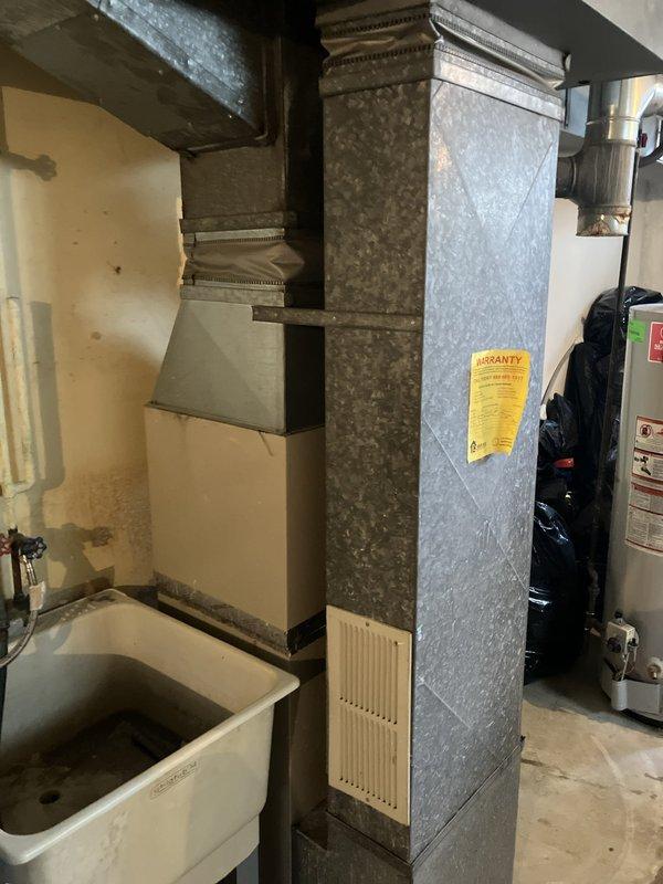 Responded to service call for air conditioning system not cooling and blowing warm air with thermostat stuck at 82°F. Upon arrival, found outdoor unit running continuously for 24 hours. Performed comprehensive system diagnostic on basement-located HVAC equipment. Inspected indoor air handler, ductwork distribution system, and associated components. Evaluated existing galvanized ductwork configuration and equipment condition. Documented system age and current operational status through visual inspection and photography. Prepared and presented full system replacement estimate to customer. Customer required completion of estimate prior to 4 PM work commitment and requested text communication due to phone calls showing as spam.