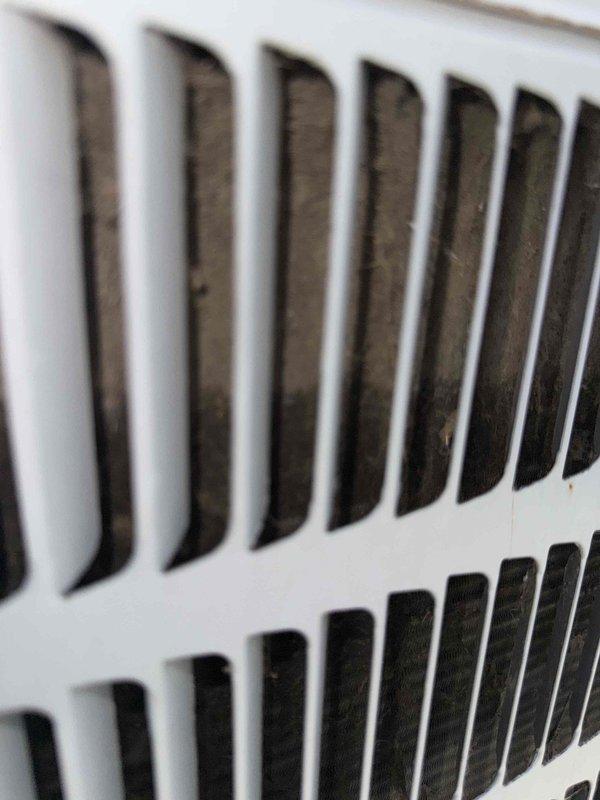 Responded to no cooling complaint on 19-year-old outdoor air conditioning unit. Upon arrival, performed visual inspection of system components and documented current condition of air handling equipment. Observed significant dust and debris accumulation on return air grille, indicating restricted airflow and lack of recent maintenance. Photographed ventilation components showing buildup on louvered surfaces. Due to age of equipment and extent of service required, appointment was rescheduled for comprehensive diagnostic evaluation and necessary repairs to restore cooling functionality.