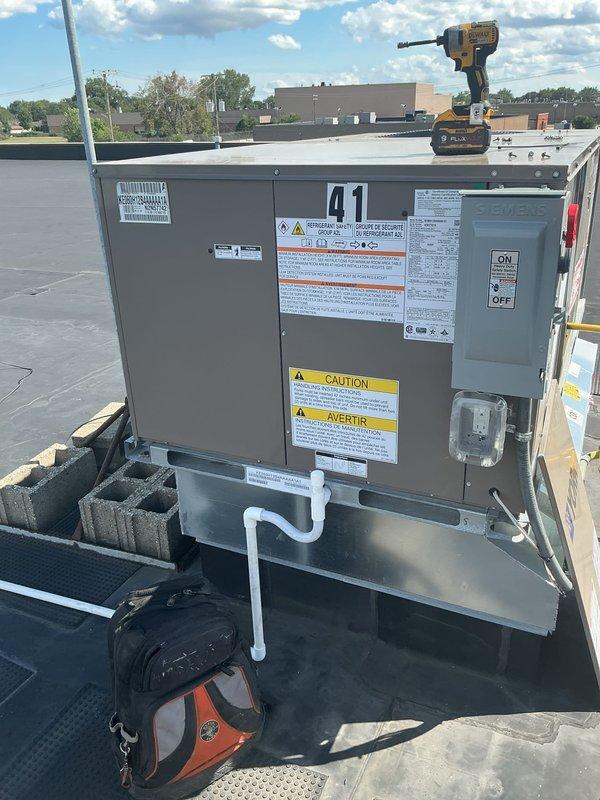 Completed full RTU replacement on unit #41 including removal and recycling of existing equipment. Installed new York packaged rooftop unit using 28-ton crane for lifting and positioning on factory-direct curb at front shipping area. Configured economizer controls, upgraded electrical disconnect, and installed White-Rodgers 1F95-0680 thermostat. Secured all required city permits and inspections. Unit is now operational with 10-year heat exchanger warranty, 5-year compressor warranty, and 2-year parts and labor coverage.