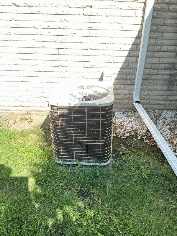 Provided estimate for complete HVAC system replacement including outdoor AC condenser unit and basement-located natural gas furnace. Existing 15-year-old system is non-operational and requires full replacement. Evaluated current installation with metal ductwork, PVC condensate drainage, and outdoor cylindrical condenser unit with protective wire grille positioned on exterior side yard.