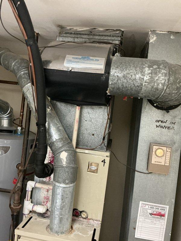 Responded to service call for water leak in ceiling near HVAC piping causing visible damage to drywall. Upon inspection, identified failed humidifier unit (MODEL PRO) mounted on furnace system as source of water intrusion. Replaced defective humidifier solenoid valve and water feed line, repaired drainage connection, and verified proper operation of humidifier system. Inspected all ductwork connections and refrigerant lines for additional moisture issues. Confirmed heating and cooling functions operational throughout service visit.