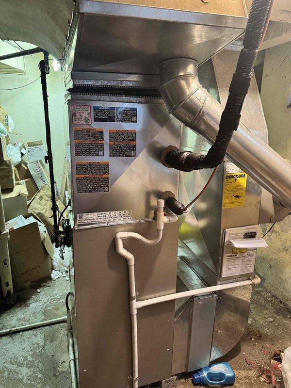 Successfully completed installation of a 5-ton air conditioning unit with uncased evaporator coil. The outdoor condenser unit was positioned in the left side yard per specifications, with all refrigerant lines reconnected and tested for proper operation. The uncased coil was installed on the existing furnace system, requiring precise measurements to ensure proper fit and airflow. All electrical connections were completed, system was charged to manufacturer specifications, and operational testing confirmed proper cooling performance. Installation was mechanical components only, with permit requested for compliance. Photos documented the completed indoor coil installation showing proper integration with the existing ductwork and furnace system.