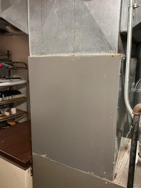 Responded to service call for 19-year-old air conditioning system reported as not cooling. Upon inspection, confirmed outdoor AC unit was non-operational and had reached end of serviceable life. Evaluated existing HVAC system including indoor furnace, ductwork configuration, and air distribution components. Documented current equipment setup with Payne furnace installation, supply plenum, and associated mechanical connections including gas lines and condensate drainage. Provided comprehensive replacement estimate for new cooling system to restore climate control functionality.