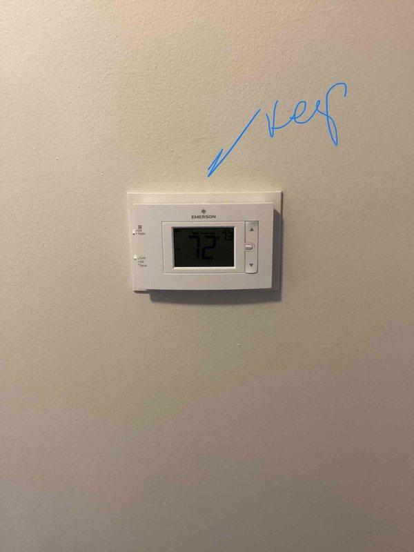 Conducted comprehensive assessment of existing heating and cooling system for replacement estimate at small residential property (0-1500 sq.ft.). Evaluated current dual outdoor condenser units positioned on concrete pad against exterior brick wall, noting refrigerant line routing and existing infrastructure. Inspected basement-mounted natural gas furnace installation and assessed ductwork configuration. Reviewed interior climate control setup including existing Emerson digital thermostat displaying current temperature settings. Documented equipment specifications, system capacity requirements, and spatial constraints for proposed HVAC replacement to provide accurate equipment sizing and installation recommendations for new heating and air conditioning system.