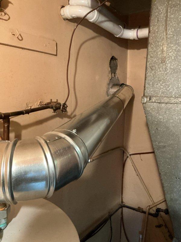 Returned to property to complete installation of chimney liner for existing water heater venting system. Successfully installed metallic flexible liner through existing chimney chase, ensuring proper diameter and clearances per manufacturer specifications and local code requirements. Connected liner to water heater flue outlet with appropriate storm collar and termination cap at chimney top. Verified draft operation and proper exhaust flow upon completion. Documented installation with photos of HVAC ductwork connections and water heater venting configuration showing copper supply lines, gas control valve, and completed exhaust vent assembly.
