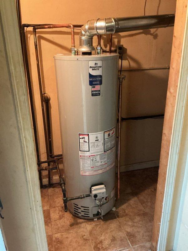 Returned to property to complete installation of chimney liner for existing water heater venting system. Successfully installed metallic flexible liner through existing chimney chase, ensuring proper diameter and clearances per manufacturer specifications and local code requirements. Connected liner to water heater flue outlet with appropriate storm collar and termination cap at chimney top. Verified draft operation and proper exhaust flow upon completion. Documented installation with photos of HVAC ductwork connections and water heater venting configuration showing copper supply lines, gas control valve, and completed exhaust vent assembly.