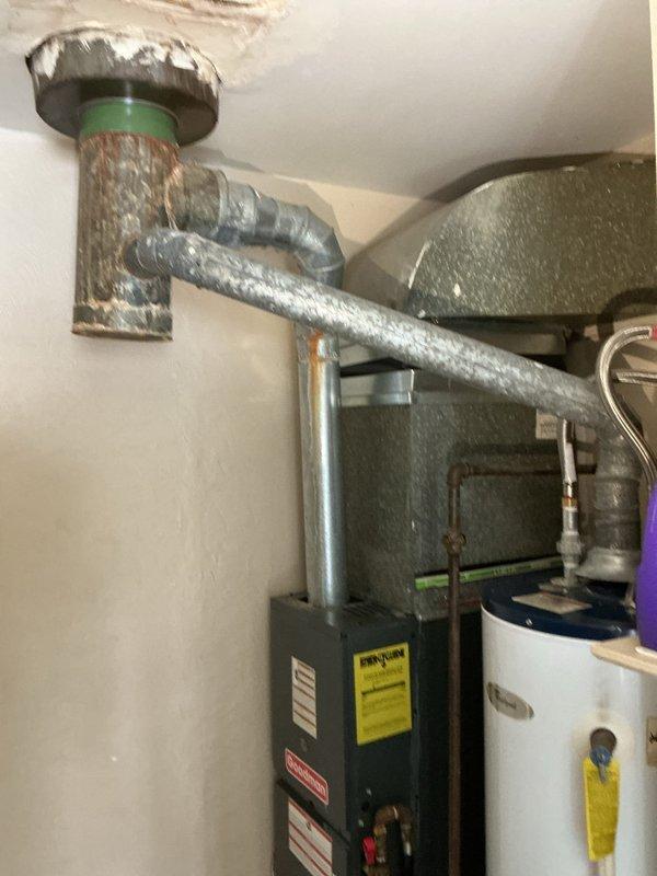 Responded to service call for water heater with pilot light that would not ignite. Upon arrival, inspected Whirlpool tanked water heater unit located in basement utility area alongside HVAC equipment. Performed diagnostic assessment of pilot assembly, thermocouple, and gas supply line. Tested gas valve operation and verified proper venting through existing exhaust system. Cleaned pilot orifice and burner assembly to ensure proper flame characteristics. Checked all copper supply line connections and fittings at top of unit for integrity. Successfully relit pilot light and verified sustained ignition. Tested main burner operation through full heating cycle to confirm proper function. Inspected surrounding area and confirmed adequate clearances per manufacturer specifications. Unit restored to full operational status with pilot remaining lit and burner cycling appropriately.