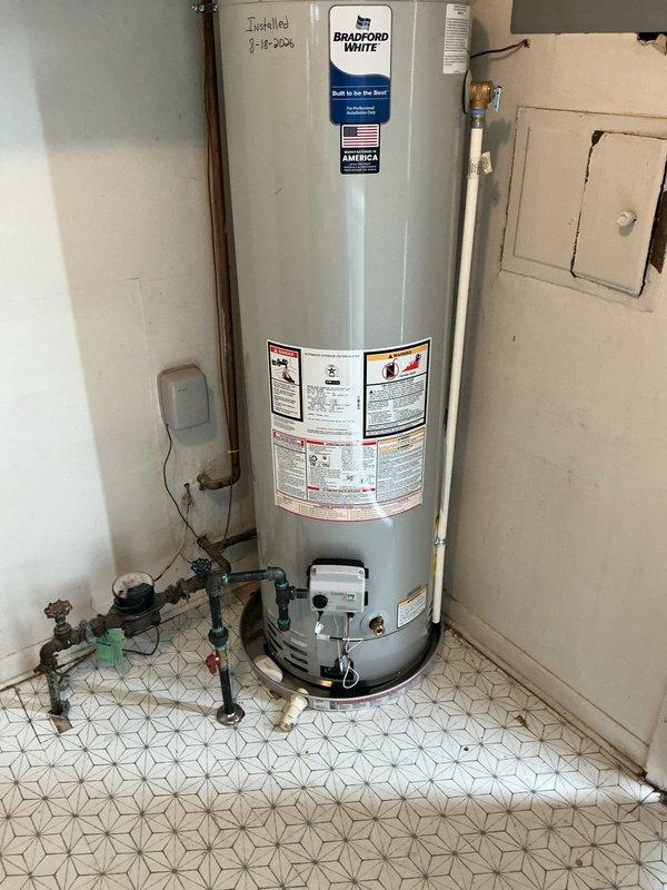 Installed a new 40-gallon Bradford White slim profile water heater with a 20-inch drain pan in residential utility room. Relocated gas line to accommodate new unit positioning, connected copper supply lines with appropriate shut-off valves and fittings, and verified all plumbing connections for proper operation. All work completed to code specifications with safety valves and expansion tank properly installed.
