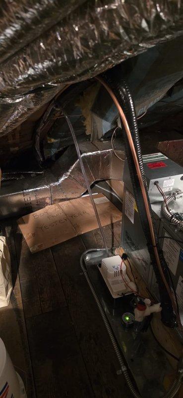 Completed replacement of Unico air handler system in attic space over two-day period. Removed existing equipment and installed new air handler unit, securing it to wooden structural framing with proper mounting. Connected flexible aluminum ductwork to unit with appropriate strapping and sealed connections. Ran refrigerant lines including copper piping from air handler, installed black flexible conduit for electrical connections, and reconnected all necessary wiring to complete mechanical installation. Mechanical permit requested for air handler reconnection work. All components installed per manufacturer specifications and positioned to optimize available space within attic structure.