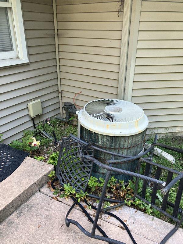 Provided comprehensive replacement estimate for 30+ year old residential HVAC system including natural gas furnace located in crawl space/utility room and outdoor air conditioning condenser unit. Current equipment remains operational but exhibits significant age-related deterioration, with outdoor unit showing extensive weathering, surface staining, and corrosion on protective cage and copper components. Assessed existing installation configuration, electrical connections, refrigerant line routing, and condensate drainage to determine optimal replacement specifications for improved energy efficiency and system reliability.