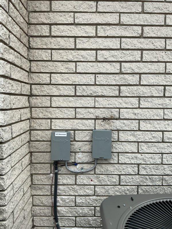 Performed site assessment and provided quote for electrical rewiring required to accommodate air conditioning unit relocation. Evaluated existing exterior disconnect box, conduit routing, and electrical panel configuration to determine scope of work. Documented current electrical infrastructure including circuit breaker panel layout and exterior AC disconnect mounting on brick exterior wall to develop comprehensive rewiring plan for equipment repositioning.