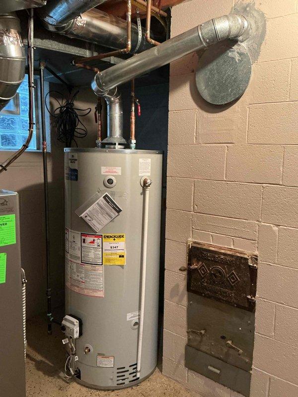 Successfully installed a 75-gallon tanked water heater in basement utility area. Completed all necessary plumbing connections using copper supply lines with shutoff valves, established proper venting through existing ductwork system to exterior wall penetration, and reconnected all mechanical components per code requirements. Mechanical permit was requested and installation performed in compliance with applicable standards.