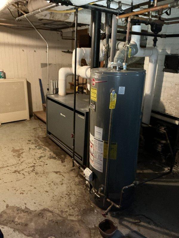 Responded to service call for tanked water heater that would not stay lit. Upon arrival, accessed basement utility room through side entrance per homeowner instructions. Inspected blue cylindrical residential water heater unit and associated gas supply line, pilot assembly, thermocouple, and burner components. Diagnosed pilot light failure preventing unit from maintaining ignition. Performed troubleshooting of gas control valve, tested thermocouple operation, and cleaned pilot orifice. Verified proper gas flow and pressure to burner assembly. Re-lit pilot light, confirmed stable flame, and tested burner ignition cycle for proper operation. Inspected all plumbing connections at top of unit including copper hot water outlet and cold water inlet for leaks. Verified temperature and pressure relief valve functionality and checked flue pipe connections for proper draft. Unit restored to full operational status with pilot remaining lit and burner cycling normally to maintain water temperature