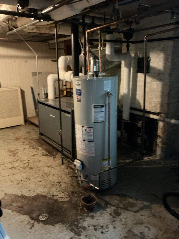 Responded to service call for tanked water heater that would not stay lit. Upon arrival, accessed basement utility room through side entrance per homeowner instructions. Inspected blue cylindrical residential water heater unit and associated gas supply line, pilot assembly, thermocouple, and burner components. Diagnosed pilot light failure preventing unit from maintaining ignition. Performed troubleshooting of gas control valve, tested thermocouple operation, and cleaned pilot orifice. Verified proper gas flow and pressure to burner assembly. Re-lit pilot light, confirmed stable flame, and tested burner ignition cycle for proper operation. Inspected all plumbing connections at top of unit including copper hot water outlet and cold water inlet for leaks. Verified temperature and pressure relief valve functionality and checked flue pipe connections for proper draft. Unit restored to full operational status with pilot remaining lit and burner cycling normally to maintain water temperature