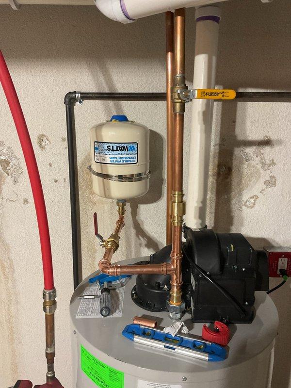 Completed comprehensive plumbing system upgrades including replacement of pressure vacuum breaker (PVB) with added unions and downstream blow-out port, followed by device registration and certification. Rebuilt kitchen water supply risers with new shutoff stops and installed hammer arrestor for dishwasher to eliminate water hammer. Added swing check valve to water heater cold water riser and installed expansion tank with proper mounting and connections. Performed water heater flush to remove sediment buildup and ensure optimal performance.