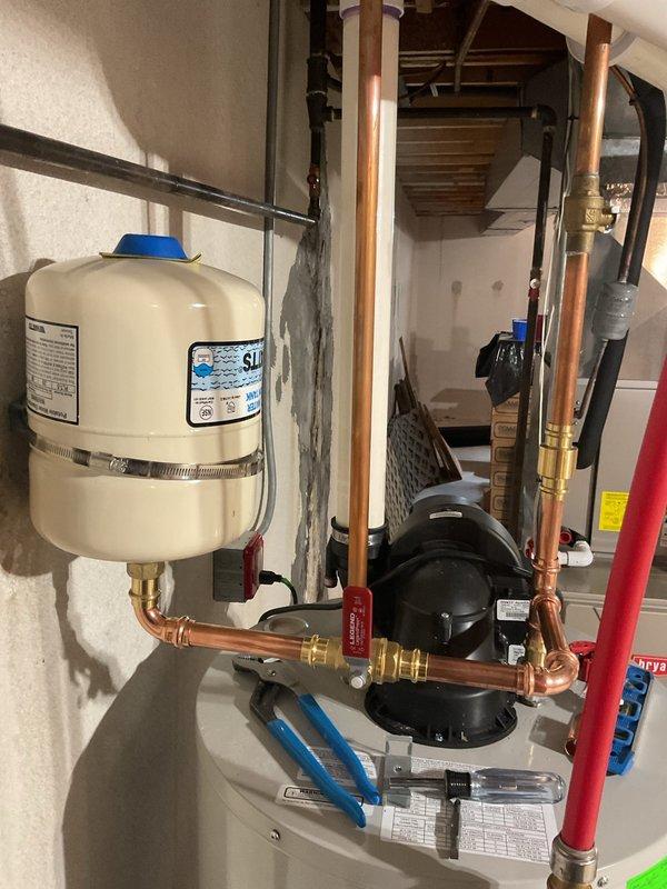Completed comprehensive plumbing system upgrades including replacement of pressure vacuum breaker (PVB) with added unions and downstream blow-out port, followed by device registration and certification. Rebuilt kitchen water supply risers with new shutoff stops and installed hammer arrestor for dishwasher to eliminate water hammer. Added swing check valve to water heater cold water riser and installed expansion tank with proper mounting and connections. Performed water heater flush to remove sediment buildup and ensure optimal performance.