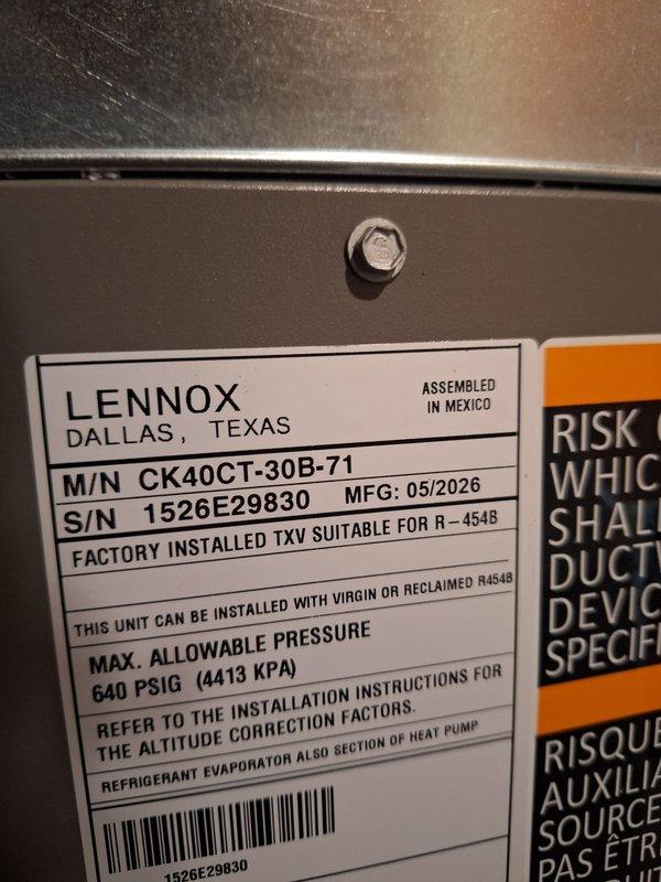 Successfully completed installation of a 2-ton Lennox air conditioning system with matching evaporator coil at rear location of residence. Installed new Lennox condensing unit (Model CK40CT-30B-71) on rubber isolation pad outside structure near glass block window, utilizing R-454B refrigerant per manufacturer specifications. Positioned unit with proper clearances for service access and airflow. Completed electrical reconnection and mechanical connections per code requirements. Requested mechanical and electrical permits for installation compliance. System installed, tested, and left operational.