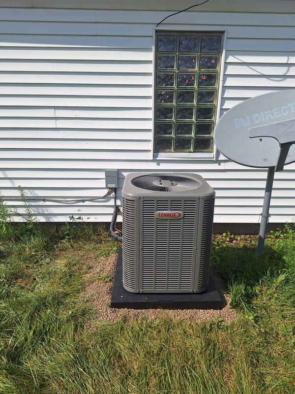 Successfully completed installation of a 2-ton Lennox air conditioning system with matching evaporator coil at rear location of residence. Installed new Lennox condensing unit (Model CK40CT-30B-71) on rubber isolation pad outside structure near glass block window, utilizing R-454B refrigerant per manufacturer specifications. Positioned unit with proper clearances for service access and airflow. Completed electrical reconnection and mechanical connections per code requirements. Requested mechanical and electrical permits for installation compliance. System installed, tested, and left operational.