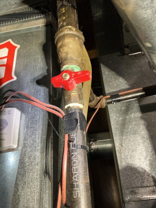 Responded to no-cool complaint on 10-year-old basement AC unit experiencing poor performance during humid conditions. Upon inspection, discovered compromised refrigerant lines with visible wear, deteriorated insulation, and potential leak points on copper piping. Examined compressor electrical connections, noting accumulated dust and aging wire terminals on motor assembly. System showed signs of reduced efficiency consistent with age and lack of maintenance. Documented equipment condition with photos of refrigerant valve assembly and compressor wiring harness for customer review and recommended comprehensive system evaluation to determine whether repair or replacement would be most cost-effective given unit age and current performance issues.