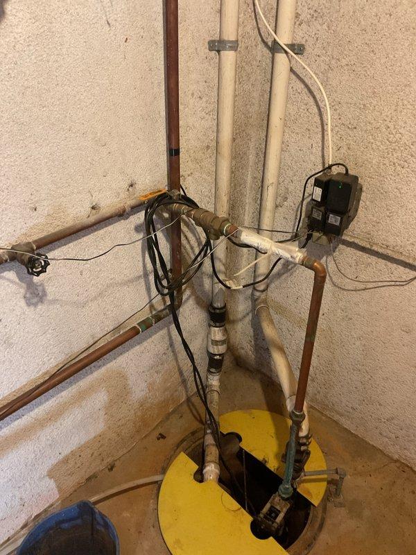 Responded to a non-draining sink that had been previously snaked 20 feet with no lasting results. Upon inspection, identified the issue as a sump pump drainage system with potential backup concerns in the basement utility area. Assessed the copper piping configuration, sump pump basin, and discharge lines connected to the drainage system. Cleared the obstruction and verified proper water flow through the sump pump discharge to restore full drainage functionality.