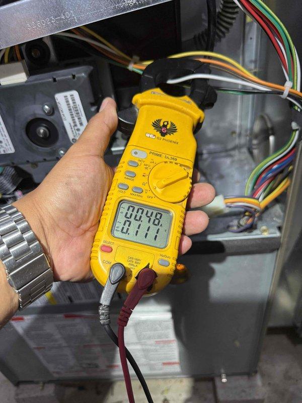 Completed comprehensive tune-up and safety inspection on 25-year-old furnace system located in basement. Performed electrical diagnostics using digital multimeter to verify proper voltage and amperage readings across control board and system components. Inspection included evaluation of humidifier operation, thermostat functionality, hot water tank condition, blower assembly, wiring connections, and all safety controls to ensure system is operating within manufacturer specifications.