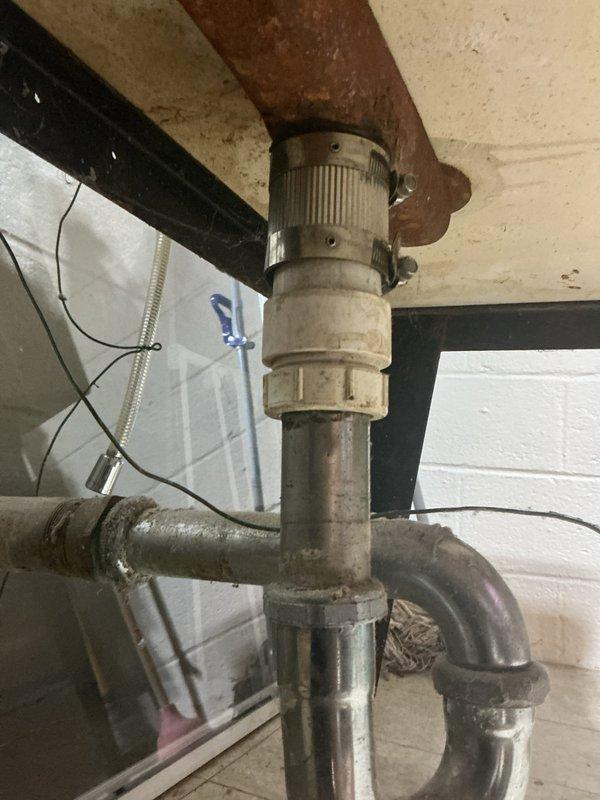 Responded to service call for water leak located under laundry tub and faucet. Upon inspection, identified leaking components in the plumbing assembly including corroded shutoff valves and deteriorating pipe connections in the basement utility area beneath the laundry room. The existing plumbing system showed significant aging with visible rust formation on valve handles and discoloration on metal piping. Documented the condition of the sump pump assembly, exposed piping configuration, and compromised valve mechanisms through photographic evidence. Provided detailed assessment and quote for necessary repairs to address the active leak and prevent further water damage.