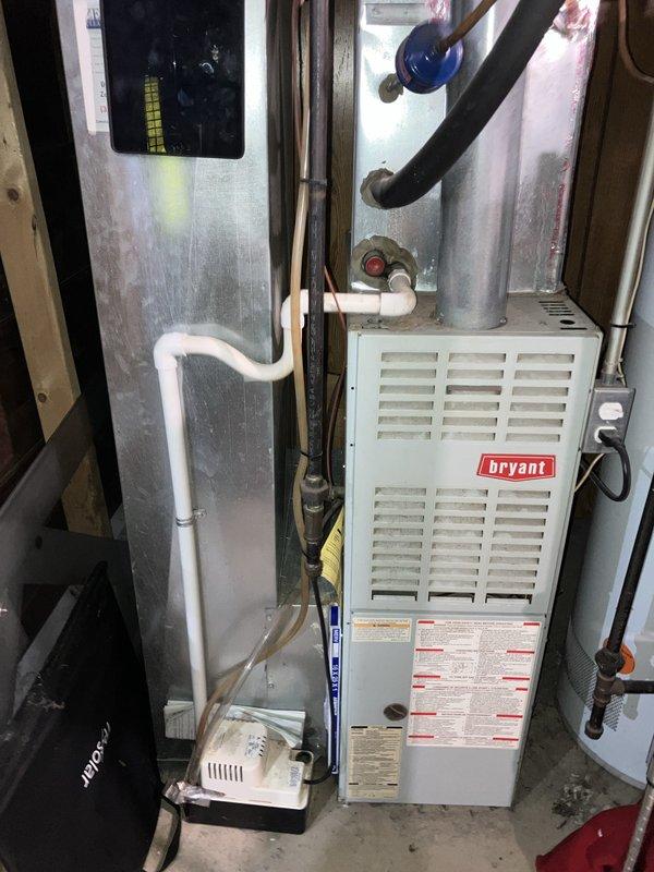 Completed HVAC system estimate for replacement of underperforming 10-year-old air conditioning unit and furnace located in basement. Customer reported inadequate cooling performance during humid conditions, with AC providing minimal cool air output. Assessed existing Bryant furnace installation with associated ductwork, refrigerant lines, condensate pump, and exterior condensing unit connections. Provided comprehensive replacement estimate for both heating and cooling equipment to address system inefficiency and performance concerns.