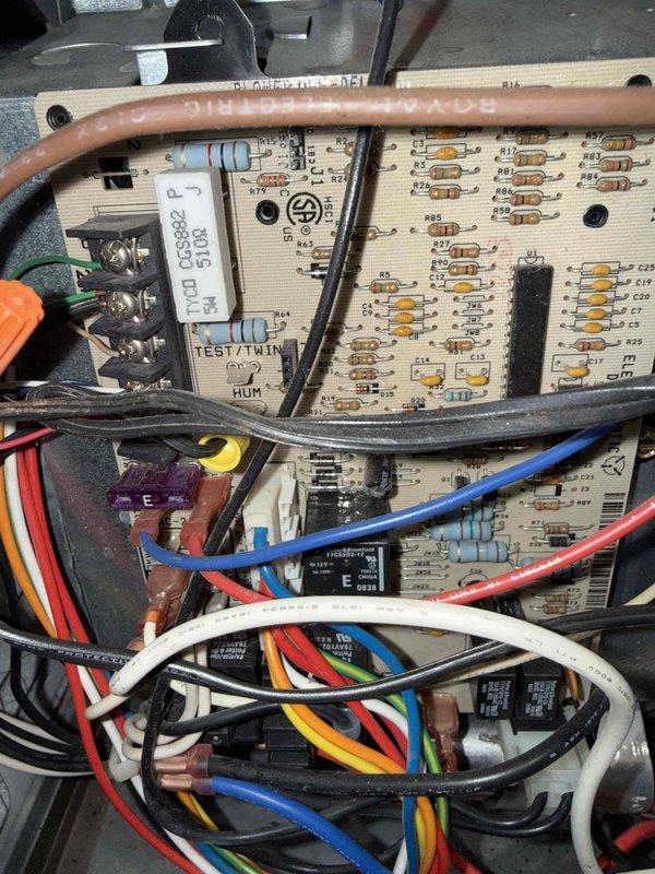 Responded to no cooling complaint on 20-year-old AC unit located in basement. Upon arrival, inspected control board assembly and electrical components for proper operation. Utilized clamp meter to perform diagnostic testing, measuring voltage and amperage readings on system circuits. Control board showed signs of age with visible discoloration on components. Checked all wire connections at terminal blocks and verified proper control signals. Evaluated refrigerant charge levels and overall system performance to determine root cause of cooling deficiency.