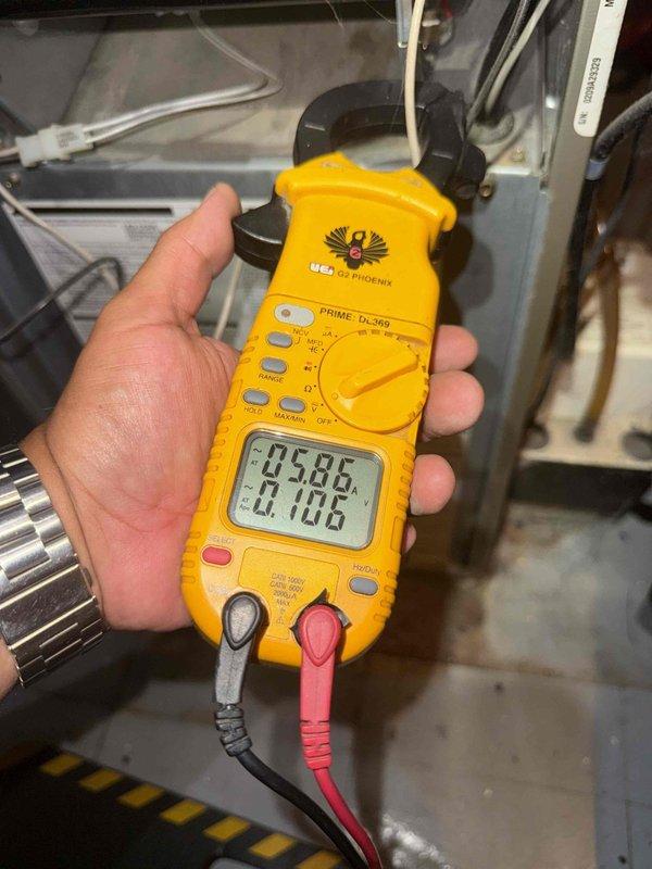 Responded to no cooling complaint on 20-year-old AC unit located in basement. Upon arrival, inspected control board assembly and electrical components for proper operation. Utilized clamp meter to perform diagnostic testing, measuring voltage and amperage readings on system circuits. Control board showed signs of age with visible discoloration on components. Checked all wire connections at terminal blocks and verified proper control signals. Evaluated refrigerant charge levels and overall system performance to determine root cause of cooling deficiency.