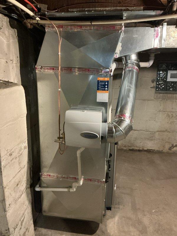 Completed full HVAC system replacement in residential basement, installing new 45,000 BTU furnace and 1.5 ton air conditioning unit. Installed Ecobee 3 Lite smart thermostat for enhanced climate control and programming capabilities. Mounted new furnace with proper venting system, including metallic ductwork and exhaust piping routed through existing infrastructure. Connected air handler plenum to furnace with secure ductwork transitions, ensuring proper airflow distribution throughout residence.

Ran and insulated copper refrigerant lines from indoor air handler to outdoor condensing unit located in rear yard, with professional line set installation and proper insulation to prevent condensation. Installed condensate drain system using PVC piping for efficient moisture removal from system. Reconnected all existing ductwork to new equipment with proper sealing and metallic tape application at all joints to prevent air leakage.

Integrated humidifier into system for whole-home humidity co