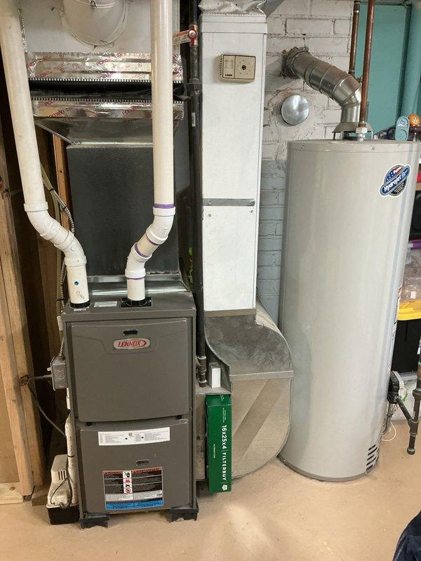 Completed comprehensive Gold AC Inspection on a 6-year-old Lennox HVAC system with basement-located air handler and exterior condenser unit. Performed multi-point inspection including visual assessment of furnace, air handler, ductwork, condensate drainage system, electrical connections, and outdoor condenser unit condition. Verified proper equipment operation, checked refrigerant lines, inspected condenser coil and fan assembly, and confirmed adequate clearance around outdoor unit with appropriate landscaping maintenance for optimal airflow and system performance.