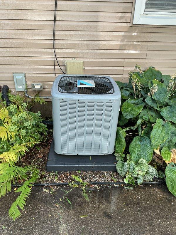 Completed comprehensive Gold AC Inspection on a 6-year-old Lennox HVAC system with basement-located air handler and exterior condenser unit. Performed multi-point inspection including visual assessment of furnace, air handler, ductwork, condensate drainage system, electrical connections, and outdoor condenser unit condition. Verified proper equipment operation, checked refrigerant lines, inspected condenser coil and fan assembly, and confirmed adequate clearance around outdoor unit with appropriate landscaping maintenance for optimal airflow and system performance.