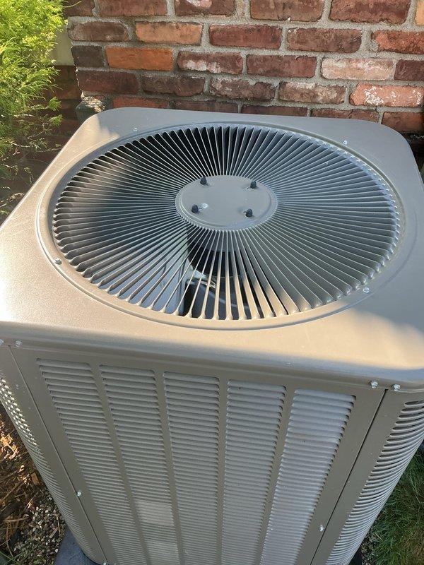 Responded to no cooling complaint on one-year-old AC system located in attic. Upon inspection, found outdoor condenser unit with heavily restricted airflow due to significant dust and debris accumulation on exterior grille and condenser coils. Cleaned condenser coils and fan grille, removed debris buildup from all exterior surfaces, and verified proper airflow restoration. System tested and confirmed cooling operation restored to normal parameters.