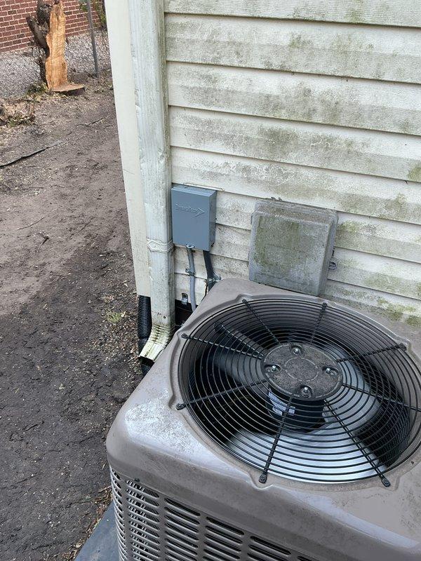 Completed comprehensive Gold AC inspection on 3-year-old system with basement-located air handler and exterior condenser unit. Performed full system evaluation including refrigerant pressures, electrical connections, condensate drainage, and airflow measurements. Inspected outdoor condenser unit mounted on concrete pad, noting operational fan assembly and proper ventilation clearances. Examined basement mechanical components including PVC condensate drain lines with valve assembly, copper refrigerant lines showing age-appropriate surface oxidation, and flexible ductwork connections. All primary system components functioning within normal parameters at time of inspection. Equipment confirmed operational by homeowner prior to service visit.