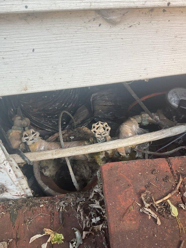 Responded to emergency service call for damaged main PVC pipe with active septic leakage in crawl space beneath residential structure. Upon inspection, accessed underhome area through exterior utility access point and located compromised section of main waste line. Existing copper supply lines and gate valves showed significant age and corrosion but remained functional. Assessed damage to PVC drainage system, identified leak source, and performed necessary repairs to compromised pipe section. Verified proper flow and eliminated active septic discharge into crawl space. Recommended ongoing monitoring of older plumbing components due to visible oxidation on copper fixtures and valves.