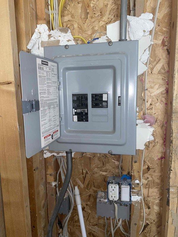 Conducted on-site estimate for new mini split installation in garage area of property currently under construction or renovation. Assessed electrical panel capacity and available circuits, evaluated optimal placement for indoor and outdoor unit components considering exposed framing and unfinished walls, and determined routing requirements for refrigerant lines, condensate drainage, and electrical connections in space with exposed ceiling joists and OSB sheathing.