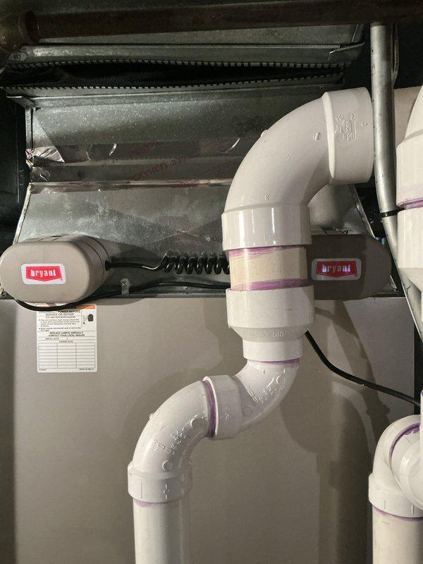 Completed comprehensive Gold-level AC inspection on 4-year-old Bryant system with coil located in basement. Inspected air handler unit, verified proper operation of condensate drainage system with safety switches, examined ductwork condition noting some material deterioration at plenum connections, and documented all equipment labels and maintenance records. All system components operational at time of inspection.