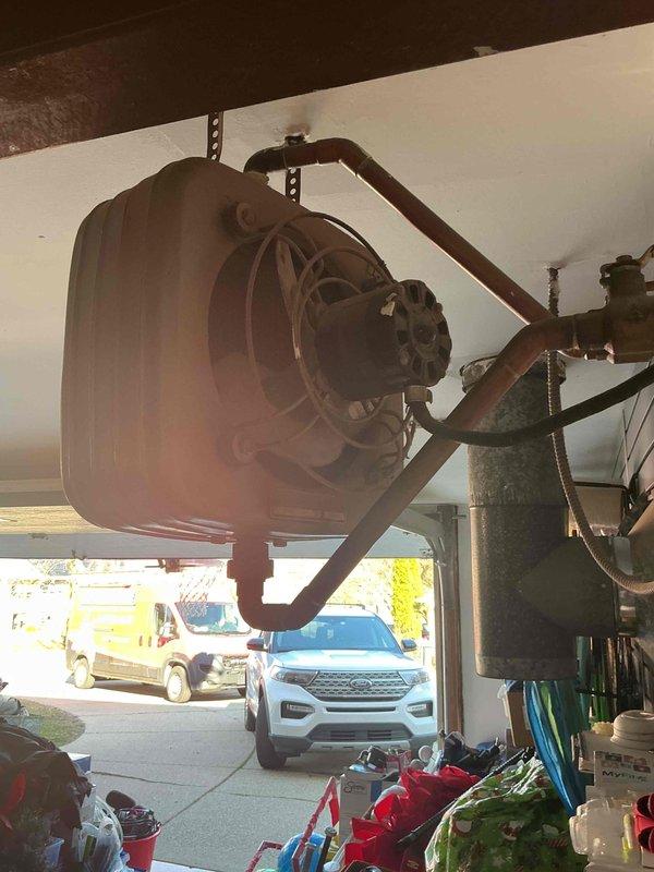 Responded to callback for boiler system with reported leak and improper wiring concerns on equipment under one year old. Inspected boiler installation in basement, verified all electrical connections per manufacturer specifications, and examined copper piping connections at pump assembly and water heater interface. Straightened and repositioned copper supply line that had been previously installed at improper angle, ensuring proper pitch and support. Tightened compression fittings at brass connections, tested system for leaks under operating pressure, and confirmed no active water discharge from piping or pump assembly. Verified circulator pump operation and pressure gauge readings within normal parameters. System tested and operational with no leaks detected at time of departure.