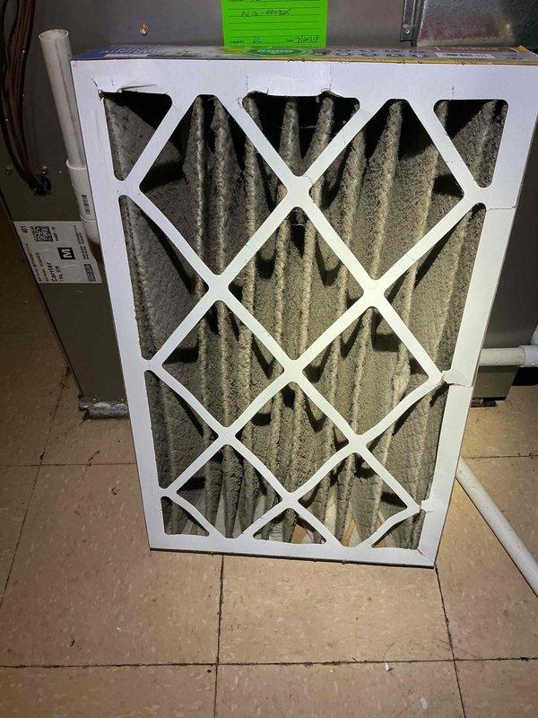 Responded to callback for air conditioning system performance issues. Upon arrival, inspected outdoor condenser unit and found unit operational with fan assembly functioning properly. Proceeded to indoor air handler where discovered severely clogged air filter with heavy accumulation of dust, debris, and particulate matter causing restricted airflow. Removed and replaced dirty filter with new filter meeting manufacturer specifications. System airflow restored to normal operating parameters. Verified proper system operation and cooling performance before departure.