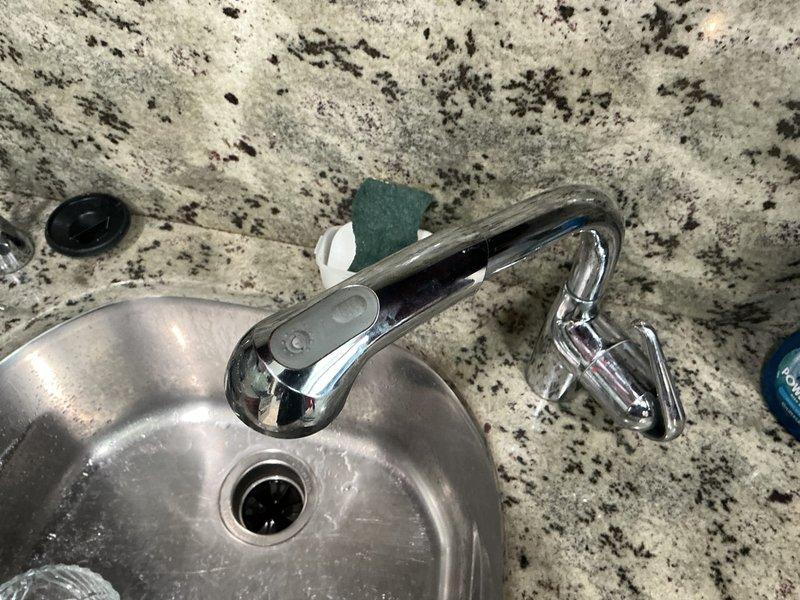 Responded to service call for toilet not filling after flushing in one bathroom and malfunctioning kitchen sink handheld sprayer. Diagnosed and repaired toilet fill valve issue to restore proper tank refilling operation. Inspected kitchen sink sprayer assembly, identified defective diverter or hose connection, and completed necessary repairs to restore full functionality of the handheld spray unit.
