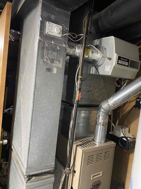 Conducted comprehensive full system evaluation of existing HVAC equipment in residential basement mechanical room. Assessed current gray metal air handler unit and beige furnace connected via flexible metallic ductwork, including evaluation of humidifier or air filtration component mounted between units. Documented existing equipment configuration, electrical connections, and ductwork layout through detailed photography. Provided customer with professional estimate options for new furnace installation and air conditioning system addition to existing setup. Reviewed mechanical room space constraints and utility connections to determine optimal equipment placement and installation requirements for proposed system upgrades.