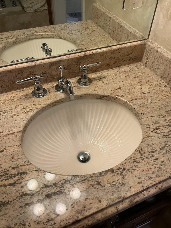 Responded to master bathroom plumbing issues involving stem leaks at stall shower and two vanity sink faucets, along with a leaking showerhead. Disassembled the three-piece chrome faucet assemblies on both undermount sink installations with granite countertops, replacing worn stem cartridges and seals to eliminate water seepage at the handles. Serviced the stall shower valve stems and replaced the showerhead to resolve dripping issue. Tested all fixtures under full water pressure to verify proper operation and confirmed no leaks at stems or spout connections upon completion.