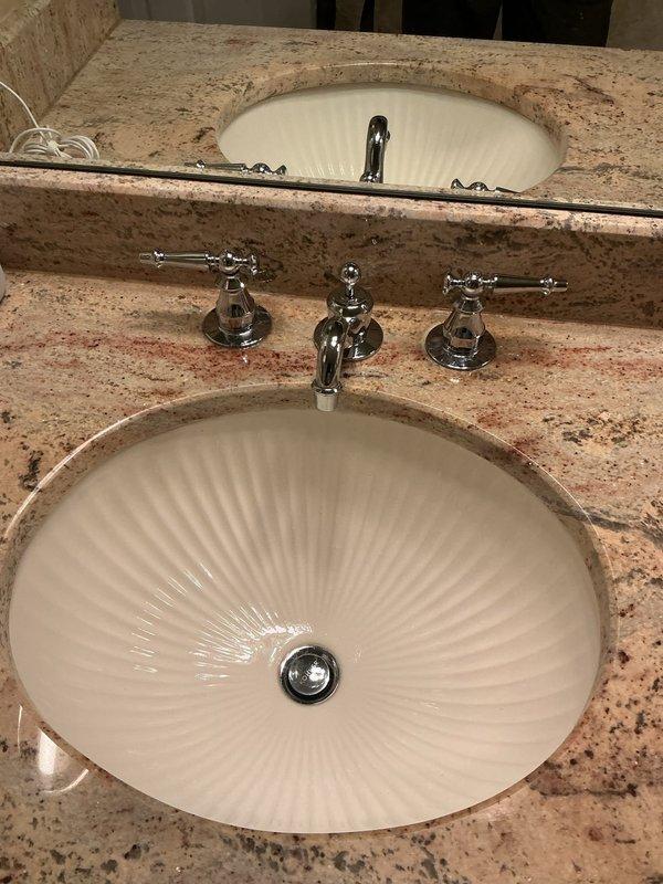 Responded to master bathroom plumbing issues involving stem leaks at stall shower and two vanity sink faucets, along with a leaking showerhead. Disassembled the three-piece chrome faucet assemblies on both undermount sink installations with granite countertops, replacing worn stem cartridges and seals to eliminate water seepage at the handles. Serviced the stall shower valve stems and replaced the showerhead to resolve dripping issue. Tested all fixtures under full water pressure to verify proper operation and confirmed no leaks at stems or spout connections upon completion.