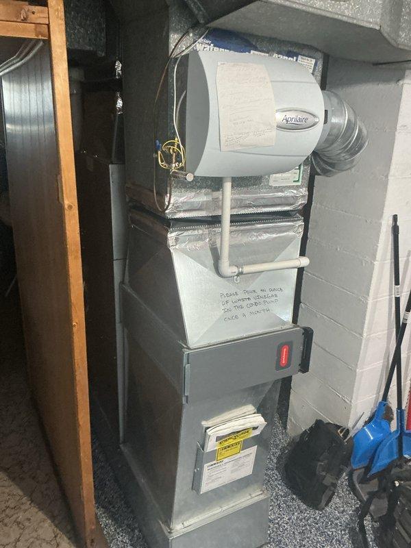 Completed comprehensive Gold Furnace Inspection on 8-year-old HVAC system located in basement. Performed thorough examination of furnace unit, including burner assembly, heat exchanger, blower motor, and all safety controls. Inspected Aprilaire humidifier mounted on furnace for proper operation and water supply connections. Verified all electrical connections, tested thermostat functionality, and examined venting system for proper installation and clearances. Checked air conditioning unit for refrigerant levels, condenser coil condition, and electrical components. Inspected all ductwork connections, PEX plumbing lines, and flexible vent piping for secure installation. Confirmed furnace filter condition and verified proper airflow throughout system. All safety switches, limit controls, and pressure switches tested and operating within manufacturer specifications. System running efficiently with no immediate concerns identified. Documented equipment condition with photos for maintenance 