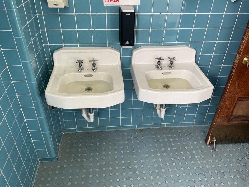Responded to service call to assess plumbing situation following wall opening and address concerns regarding incomplete toilet repairs from previous visit. Conducted thorough inspection of dual-sink bathroom installation with exposed PVC drainage system and documented existing conditions. Evaluated mechanical room piping infrastructure including flow meter installation with flanged connections and associated equipment to determine scope of required plumbing work and provide recommendations for resolution of outstanding issues.
